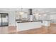 This modern kitchen features white cabinetry, stainless appliances, and a large black granite island at 4916 E Kathleen Rd, Scottsdale, AZ 85254