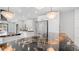 Bright kitchen boasts large islands, granite countertops, pendant lighting, stainless steel appliances, and white cabinets at 4916 E Kathleen Rd, Scottsdale, AZ 85254