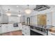 This modern kitchen features white cabinetry, stainless appliances, and a large black granite island at 4916 E Kathleen Rd, Scottsdale, AZ 85254