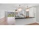 Open concept kitchen with granite countertops, island seating, pendant lighting and adjacent living room at 4916 E Kathleen Rd, Scottsdale, AZ 85254