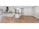 Spacious kitchen with large islands, black countertops, pendant lighting, white backsplash, and hardwood floors at 4916 E Kathleen Rd, Scottsdale, AZ 85254