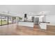 A modern kitchen features white cabinetry, stainless appliances, and a large black granite island at 4916 E Kathleen Rd, Scottsdale, AZ 85254