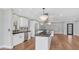 This modern kitchen features white cabinetry, stainless appliances, and a large black granite island at 4916 E Kathleen Rd, Scottsdale, AZ 85254