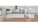 This modern kitchen features white cabinetry, stainless appliances, and a large black granite island at 4916 E Kathleen Rd, Scottsdale, AZ 85254