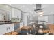This modern kitchen features white cabinetry, stainless appliances, and a large black granite island at 4916 E Kathleen Rd, Scottsdale, AZ 85254