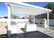 Outdoor kitchen with pergola, grill, and fireplace at 4916 E Kathleen Rd, Scottsdale, AZ 85254