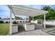 Outdoor kitchen with a built-in grill, prep area, sink, and a fireplace at 4916 E Kathleen Rd, Scottsdale, AZ 85254