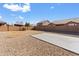 Spacious backyard featuring a large concrete slab and gravel landscaping at 4933 W Melody Ln, Laveen, AZ 85339