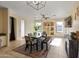 Bright dining room with a farmhouse table and access to the kitchen at 4933 W Melody Ln, Laveen, AZ 85339