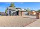 Charming ranch home with gray siding, black garage door and a well-maintained front yard at 5344 W Desert Hills Dr, Glendale, AZ 85304