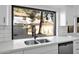 Kitchen with sink, modern faucet, and view of backyard at 5344 W Desert Hills Dr, Glendale, AZ 85304