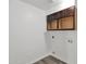 Bright laundry room with new wood cabinets and vinyl flooring at 5344 W Desert Hills Dr, Glendale, AZ 85304