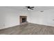 Living room with brick fireplace and gray vinyl flooring at 5344 W Desert Hills Dr, Glendale, AZ 85304