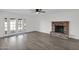 Living room with brick fireplace and French doors leading outside at 5344 W Desert Hills Dr, Glendale, AZ 85304