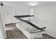 Modern staircase with dark gray railings and light wood flooring at 5344 W Desert Hills Dr, Glendale, AZ 85304