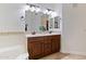 Double vanity bathroom with a large mirror and neutral tile at 5350 E Deer Valley Dr # 1418, Phoenix, AZ 85054