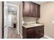 Laundry room with dark wood cabinets, granite countertop, and utility sink at 5429 E Barwick Dr, Cave Creek, AZ 85331