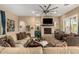 Bright living room with stone fireplace and comfortable seating area at 5429 E Barwick Dr, Cave Creek, AZ 85331