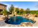 Inviting backyard oasis with a large pool, spa, and waterfall feature at 5429 E Barwick Dr, Cave Creek, AZ 85331