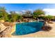 Resort style backyard with a large pool and rock waterfall at 5429 E Barwick Dr, Cave Creek, AZ 85331