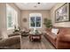 Sitting room with leather sofas, wood floors, and large window at 5429 E Barwick Dr, Cave Creek, AZ 85331