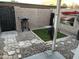 Small, private backyard with gravel, artificial turf, and a gas grill at 5813 N 59Th Dr, Glendale, AZ 85301