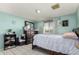 Bedroom with double bed and dresser, featuring a light teal wall at 5934 W Coronado Rd, Phoenix, AZ 85035