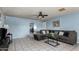 Living room with sectional sofa, coffee table, and ceiling fan at 5934 W Coronado Rd, Phoenix, AZ 85035