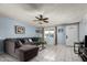 Living room with sectional sofa, coffee table, and ceiling fan at 5934 W Coronado Rd, Phoenix, AZ 85035