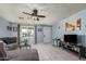 Living room with sectional sofa, coffee table, and ceiling fan at 5934 W Coronado Rd, Phoenix, AZ 85035