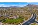 Aerial view showing neighborhood homes, playground, and mountain backdrop at 6033 E Pebbles Ct, Cave Creek, AZ 85331