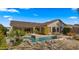 Luxury backyard with sparkling pool, fire features, & ample seating at 6033 E Pebbles Ct, Cave Creek, AZ 85331