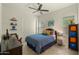 bedroom with ceiling fan, plantation shutters, and colorful decor at 6033 E Pebbles Ct, Cave Creek, AZ 85331