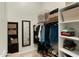 Organized walk-in closet with shelving, hanging space, and mirror at 6033 E Pebbles Ct, Cave Creek, AZ 85331