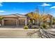 Two-car garage and welcoming front porch with desert landscaping at 6033 E Pebbles Ct, Cave Creek, AZ 85331