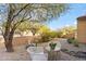 Landscaped backyard with seating area under a tree at 6231 E Mark Way # 32, Cave Creek, AZ 85331