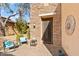 Front entry with a decorative metal door and seating area at 6231 E Mark Way # 32, Cave Creek, AZ 85331