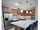 Modern kitchen features stainless steel appliances and a large island with quartz countertops at 6231 E Mark Way # 32, Cave Creek, AZ 85331