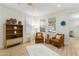 Bright living room with two orange armchairs and a wooden shelving unit at 6231 E Mark Way # 32, Cave Creek, AZ 85331