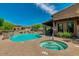 Community pool and spa with surrounding patio at 6231 E Mark Way # 32, Cave Creek, AZ 85331