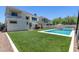 Relaxing backyard with a refreshing pool and lush green lawn at 630 W Echo Ln, Phoenix, AZ 85021