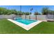 Inviting pool and spa with artificial turf and cacti at 630 W Echo Ln, Phoenix, AZ 85021