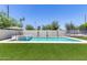 Modern rectangular pool with a spa, surrounded by artificial turf at 630 W Echo Ln, Phoenix, AZ 85021