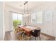 Elegant dining room with wood table and statement lighting fixture at 630 W Echo Ln, Phoenix, AZ 85021