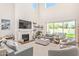 Bright living room featuring a fireplace and sliding glass doors to backyard pool at 630 W Echo Ln, Phoenix, AZ 85021