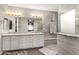 Elegant bathroom with double vanity, granite counters, and a walk-in shower at 631 W Stanley Ave, San Tan Valley, AZ 85140