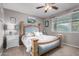 Bedroom with light blue upholstered bed and ceiling fan at 631 W Stanley Ave, San Tan Valley, AZ 85140