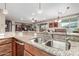 Kitchen with double sink, granite countertops and breakfast bar at 631 W Stanley Ave, San Tan Valley, AZ 85140