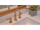 Modern bathroom sink with gold faucet and white countertop at 6425 N 79Th St, Scottsdale, AZ 85250