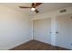 Bright bedroom with wood flooring, ceiling fan, and double closets at 6425 N 79Th St, Scottsdale, AZ 85250